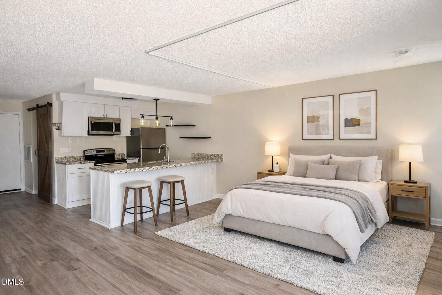 3071 Huntleigh Drive, Unit 3071 Raleigh, NC 27604 - Photo 2 of 25 a bedroom with a bed and a television