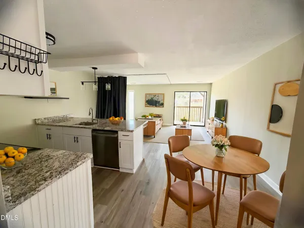 a kitchen with a dining table and chairs