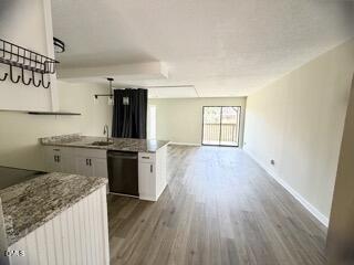 3071 Huntleigh Drive, Unit 3071 Raleigh, NC 27604 - Photo 5 of 25 a kitchen with a wooden floor and a refrigerator