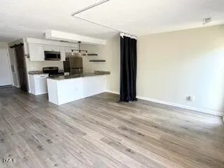 a kitchen with stainless steel appliances a refrigerator and a stove top oven
