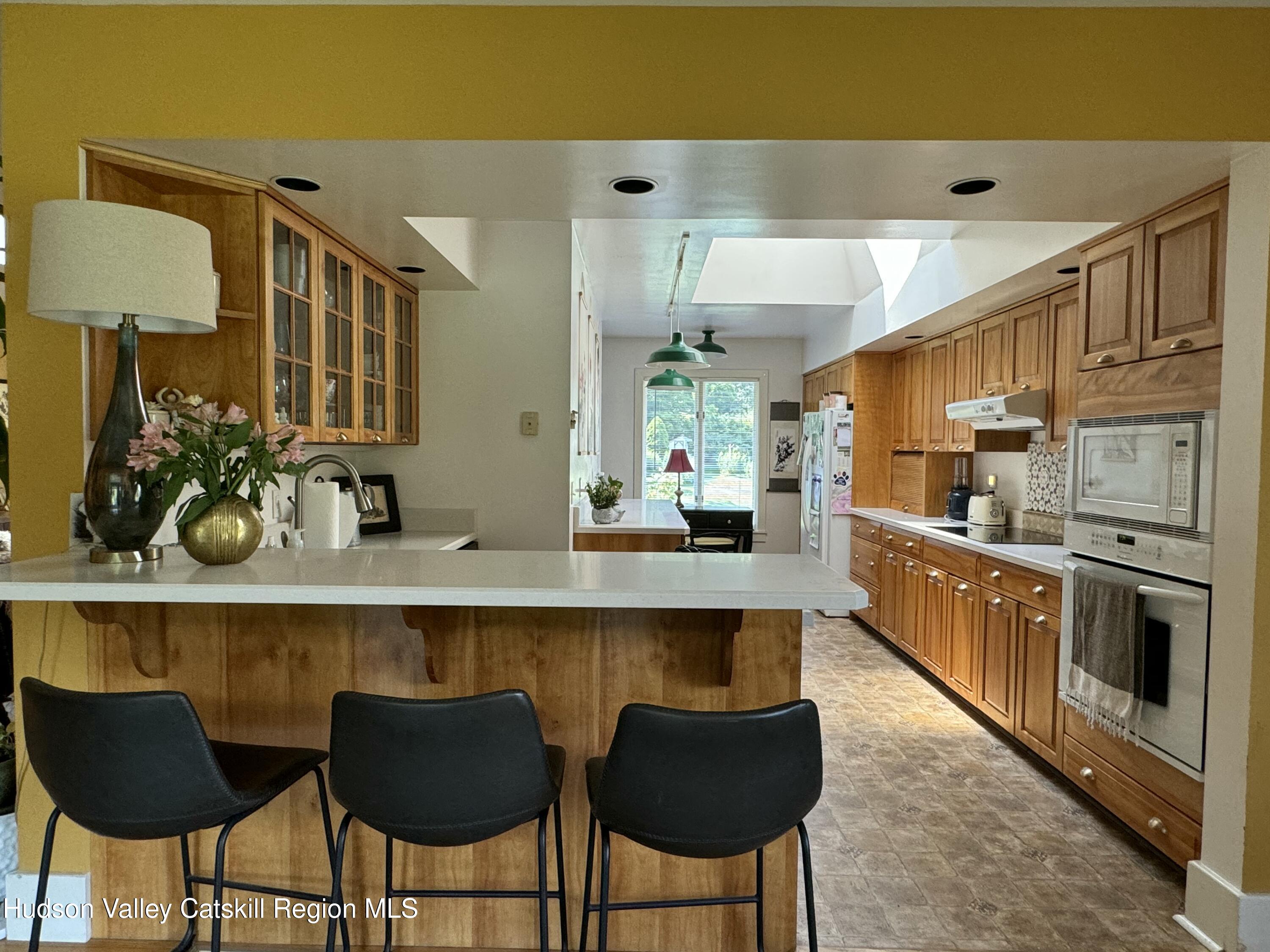 1476 County Rte 5 Canaan, NY 12029 - Photo 14 of 38 a kitchen with stainless steel appliances kitchen island granite countertop a table and chairs in it