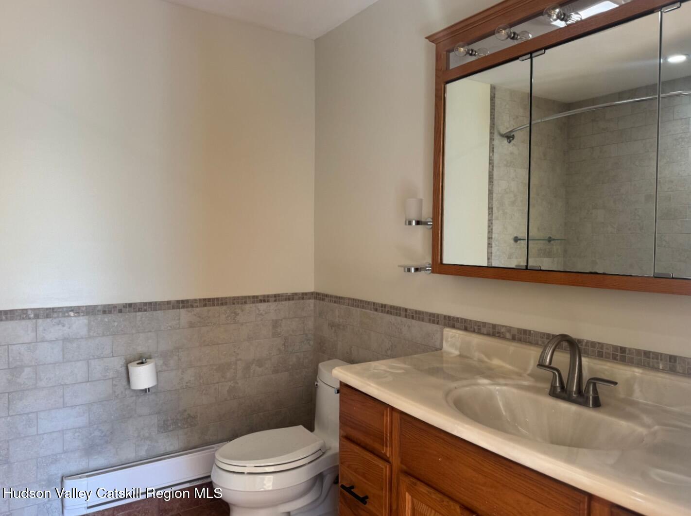 1476 County Rte 5 Canaan, NY 12029 - Photo 25 of 40 a bathroom with a granite countertop sink a toilet and a mirror