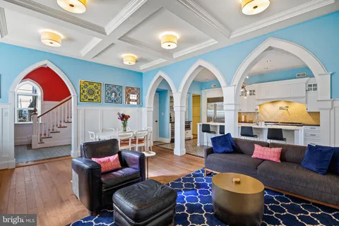a living room with furniture fireplace and wooden floor