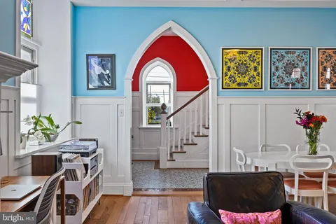 a living room with fireplace furniture and a large window