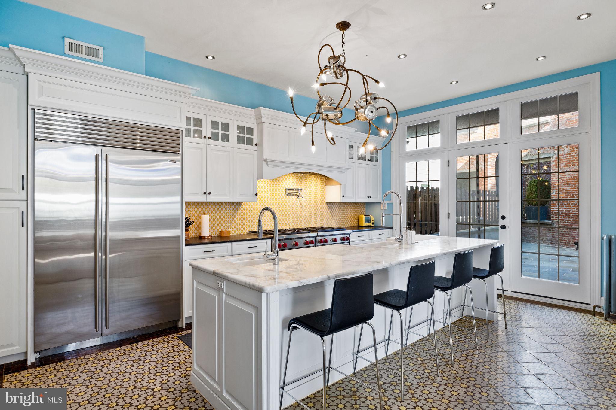 308 Monastery Avenue Philadelphia, PA 19128 - Photo 19 of 70 a kitchen with a chandelier a sink stainless steel appliances and cabinets