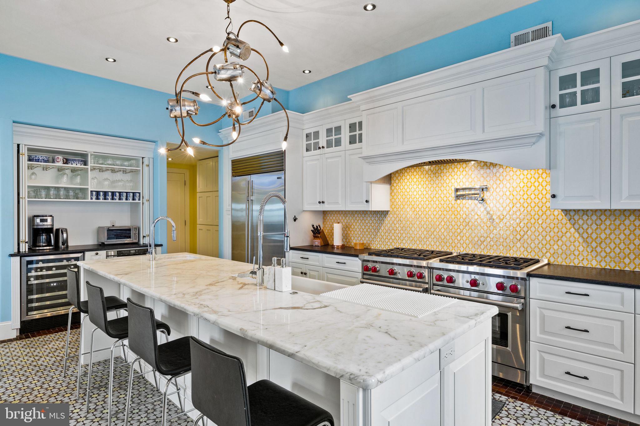 308 Monastery Avenue Philadelphia, PA 19128 - Photo 22 of 70 a kitchen with stainless steel appliances granite countertop a stove a sink dishwasher and cabinets with wooden floor