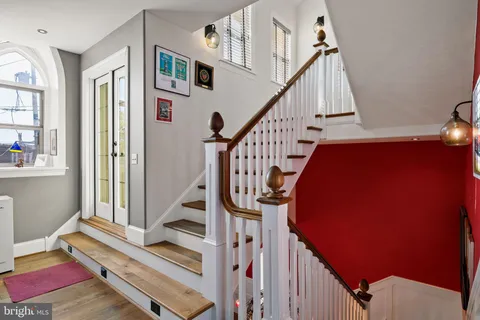 a bedroom with a bed and a couch next to a window