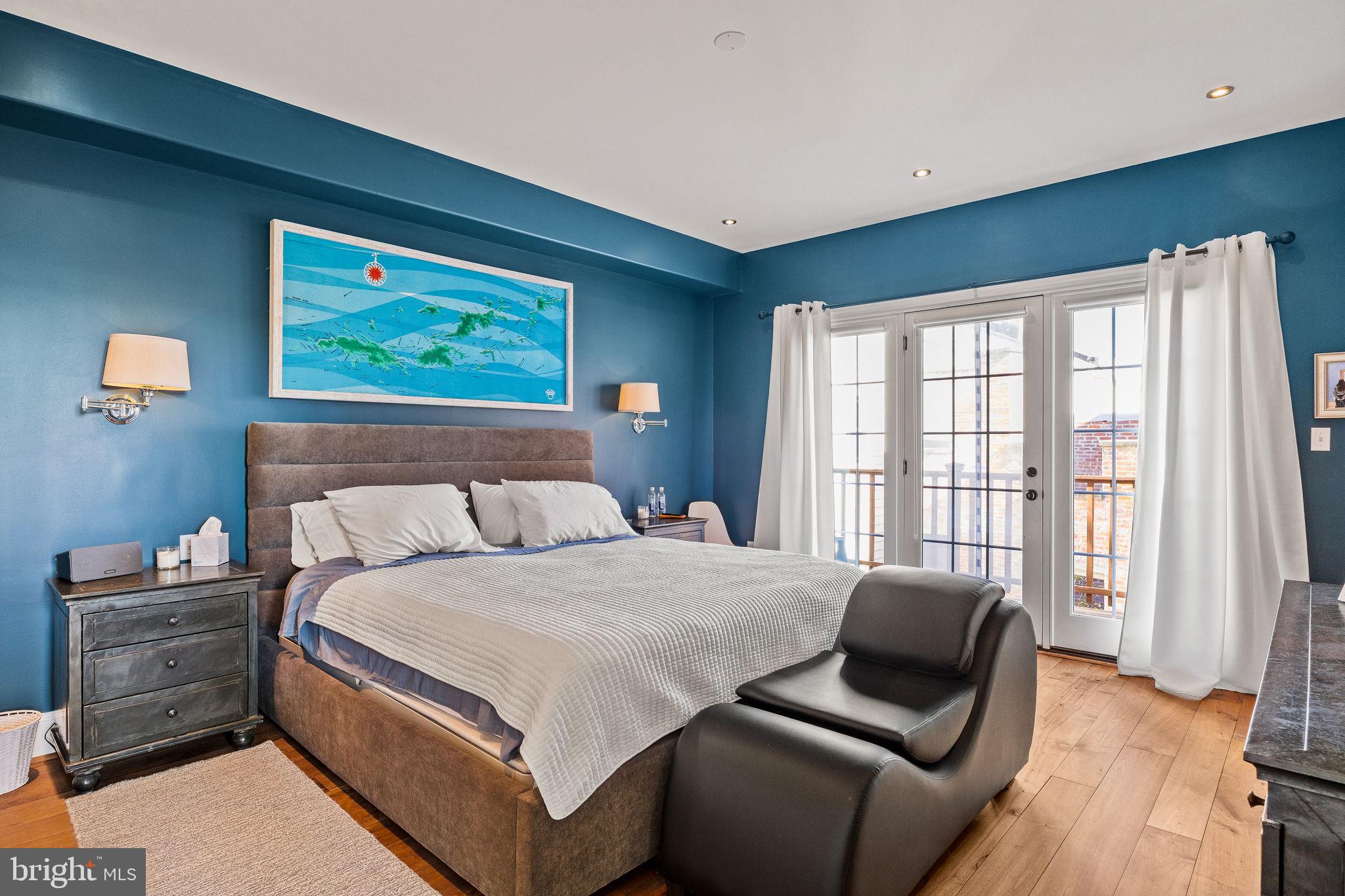 308 Monastery Avenue Philadelphia, PA 19128 - Photo 40 of 70 a bedroom with a bed and a couch next to a window