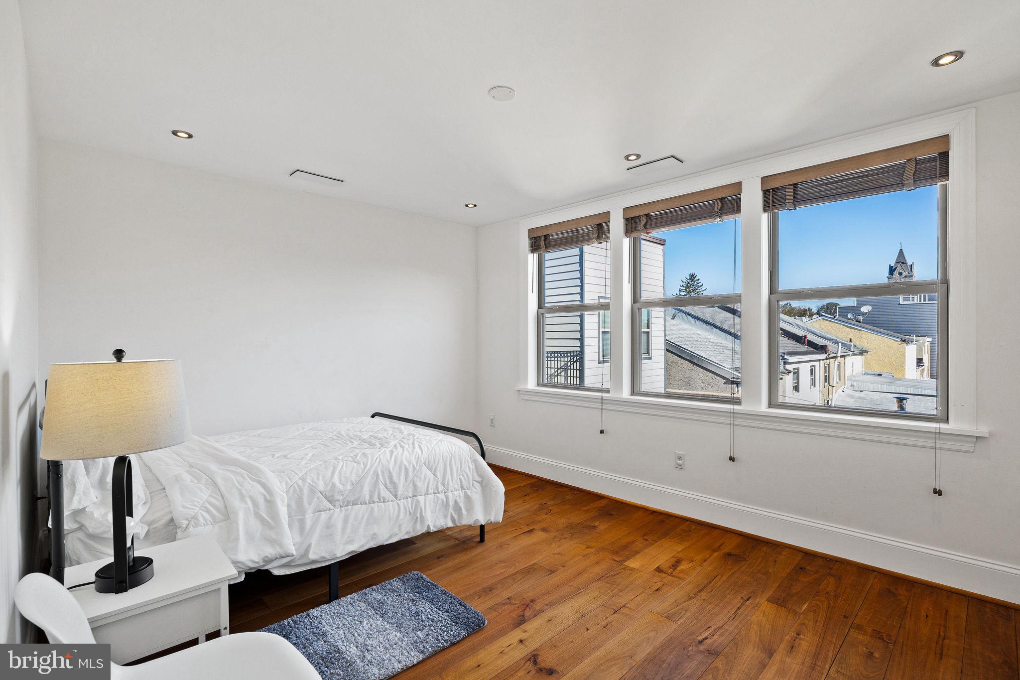308 Monastery Avenue Philadelphia, PA 19128 - Photo 58 of 70 a bedroom with a bed and wooden floor