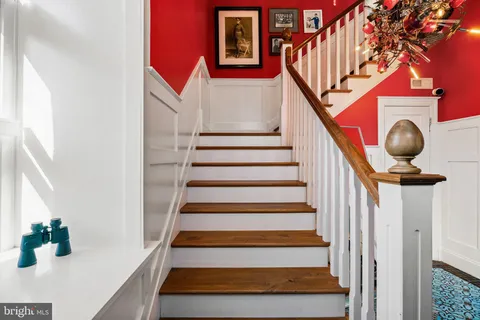 a view of a dining room with furniture wooden floor and a kitchen