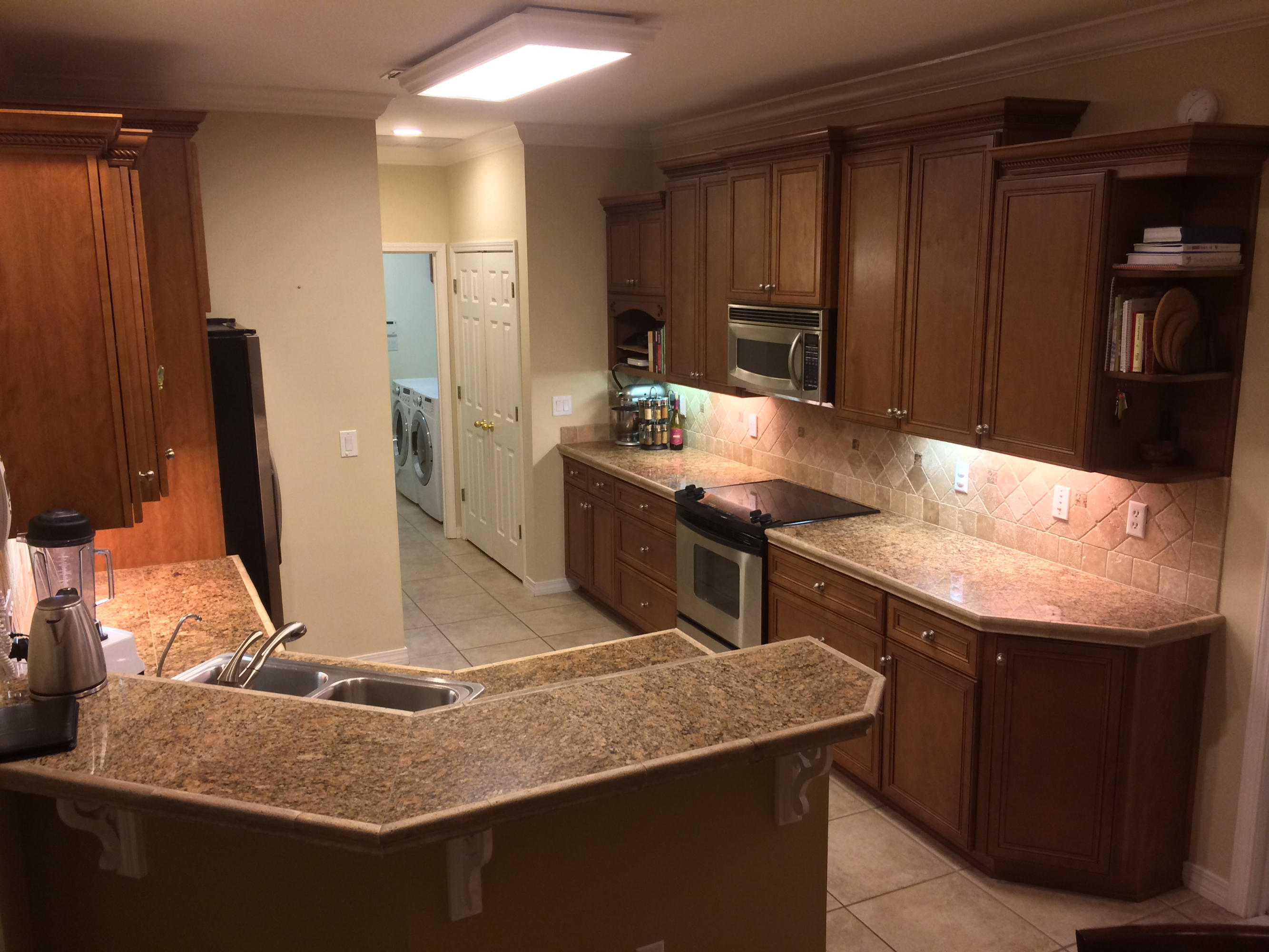 4461 Kingslynn Road Niceville, FL 32578 - Photo 11 of 38 a kitchen with stainless steel appliances granite countertop a sink refrigerator and cabinets
