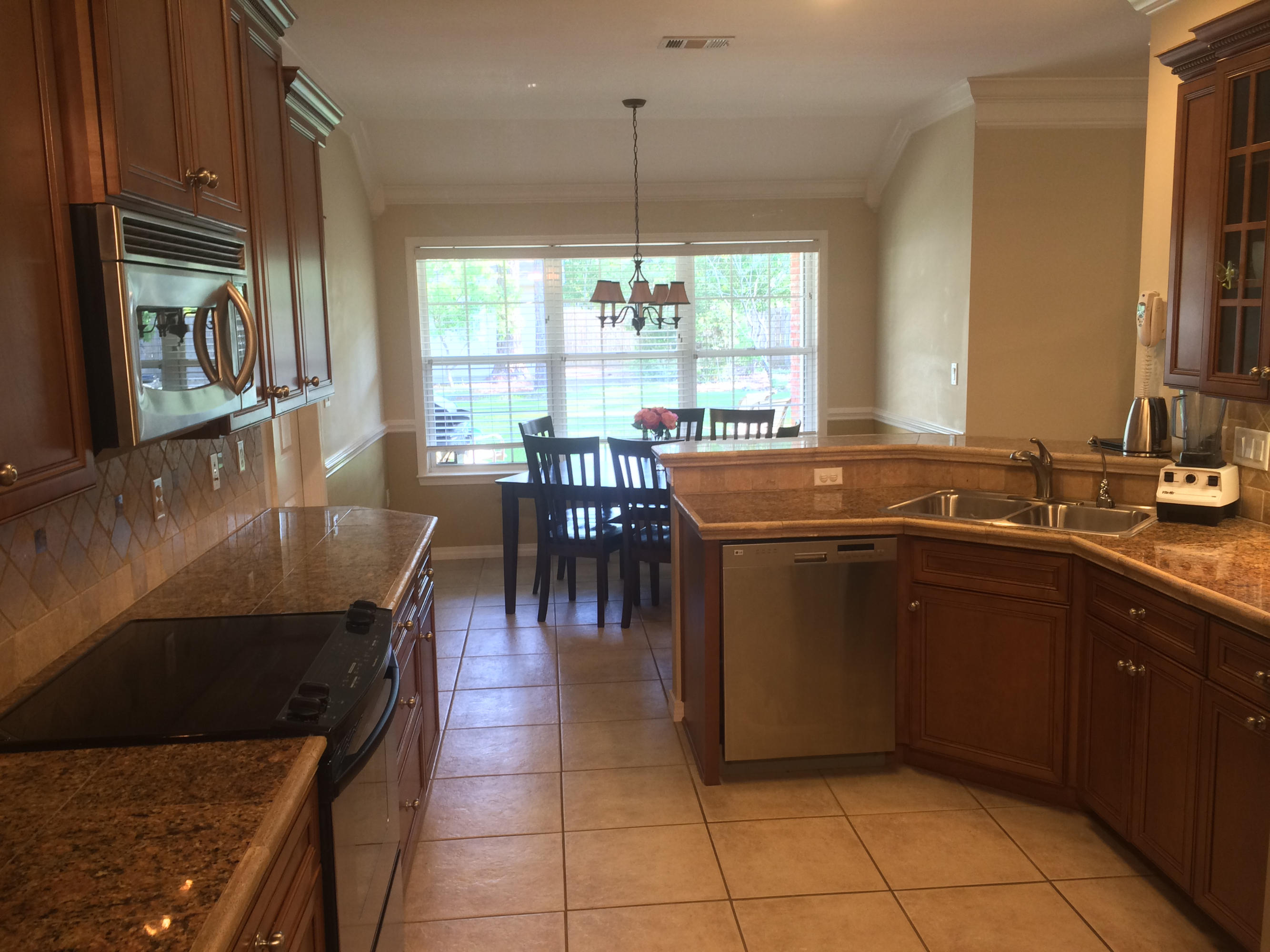 4461 Kingslynn Road Niceville, FL 32578 - Photo 13 of 38 a kitchen with a sink a counter top space and stainless steel appliances