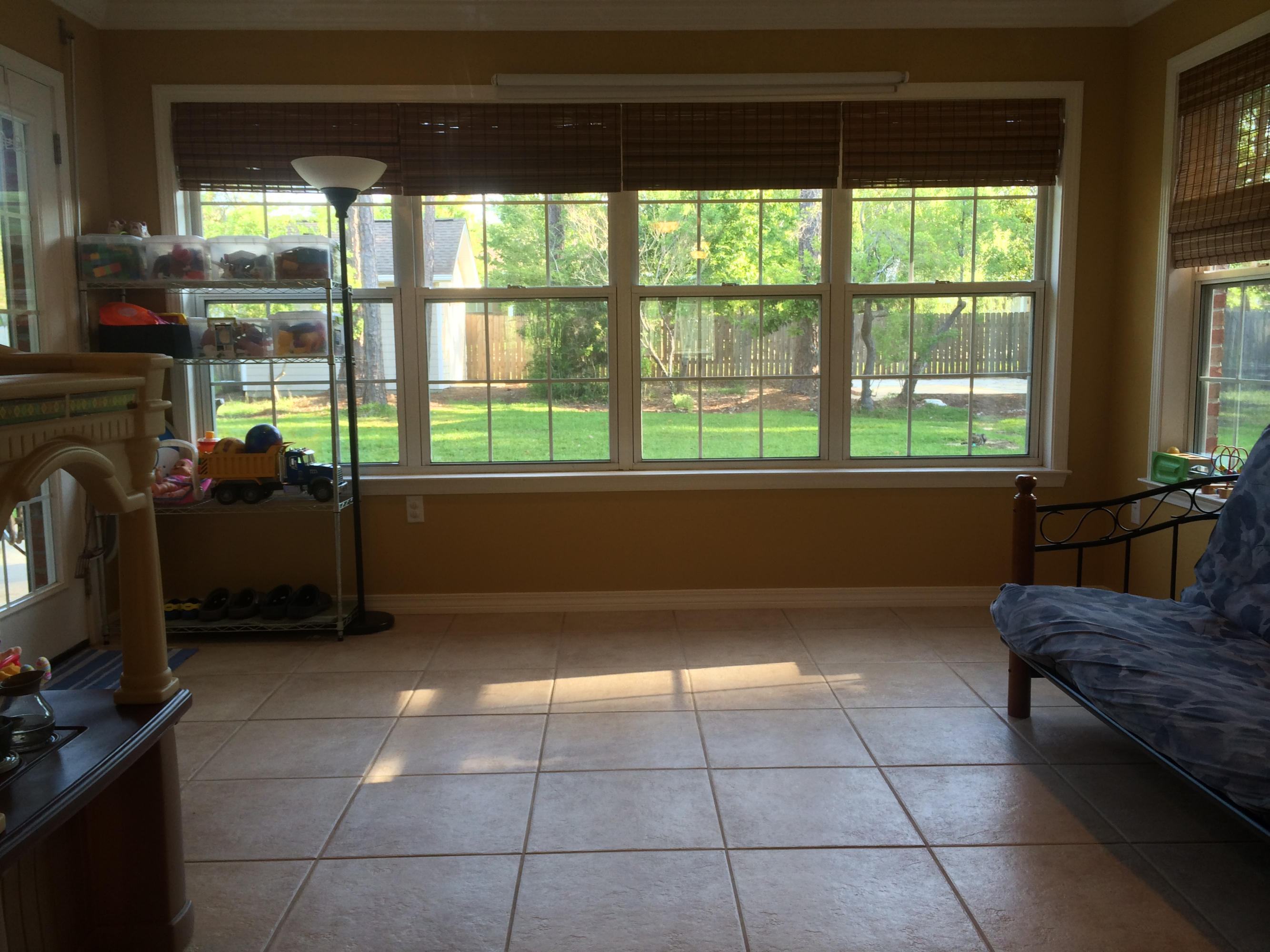 4461 Kingslynn Road Niceville, FL 32578 - Photo 16 of 38 a living room with furniture a flat screen tv and a floor to ceiling window