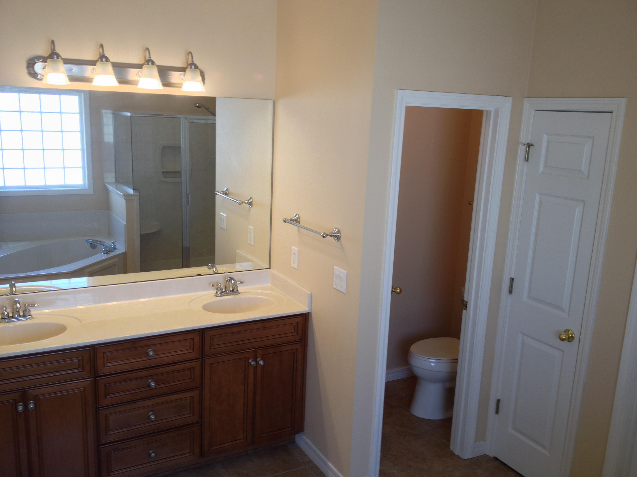 4461 Kingslynn Road Niceville, FL 32578 - Photo 21 of 38 a bathroom with a granite countertop sink toilet and mirror