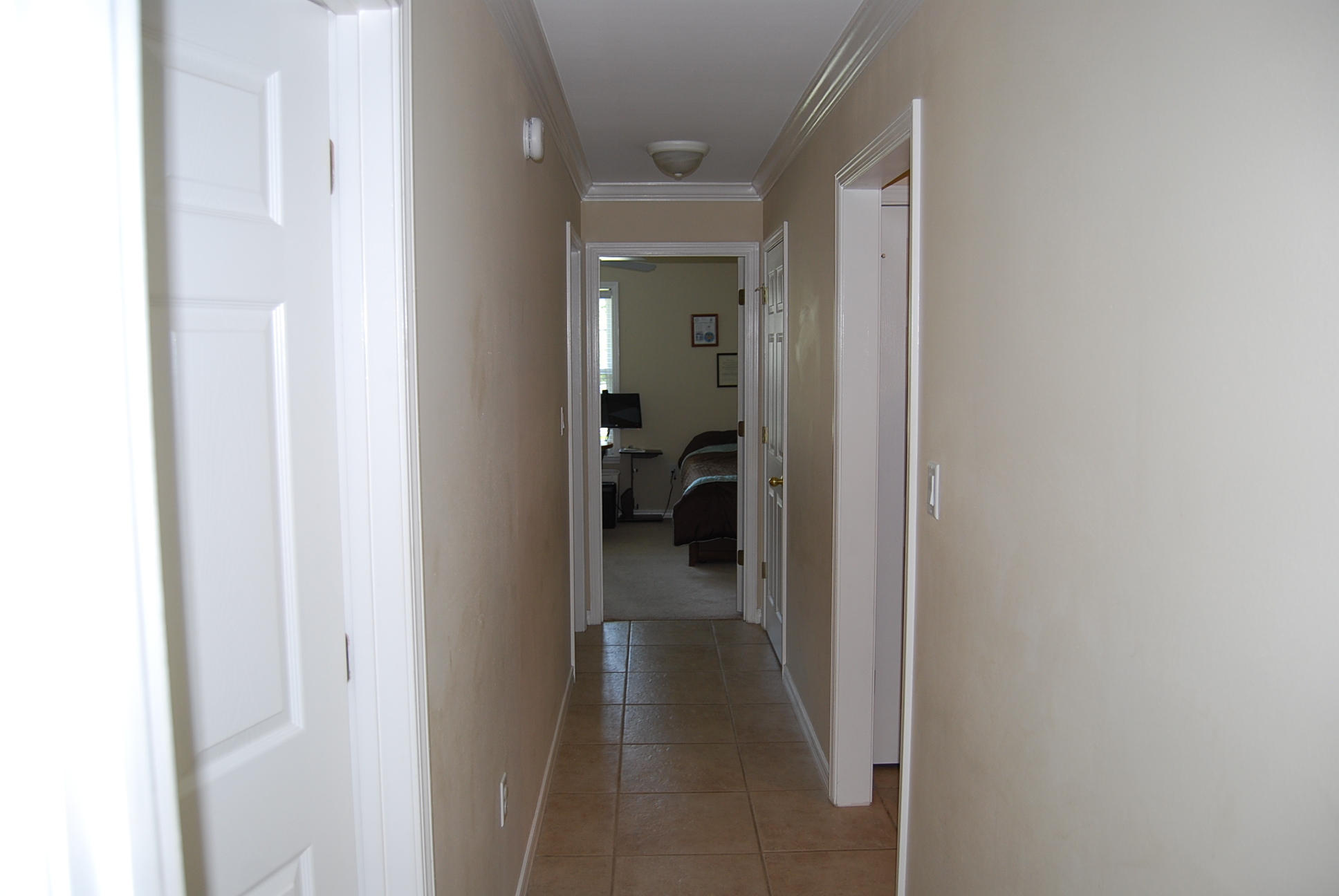 4461 Kingslynn Road Niceville, FL 32578 - Photo 23 of 38 a view of a hallway with a white walls and a bathroom with a sink