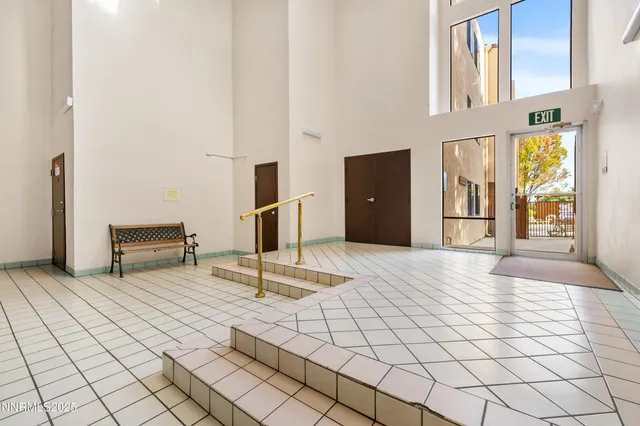 a view of a hall way with wooden cabinets