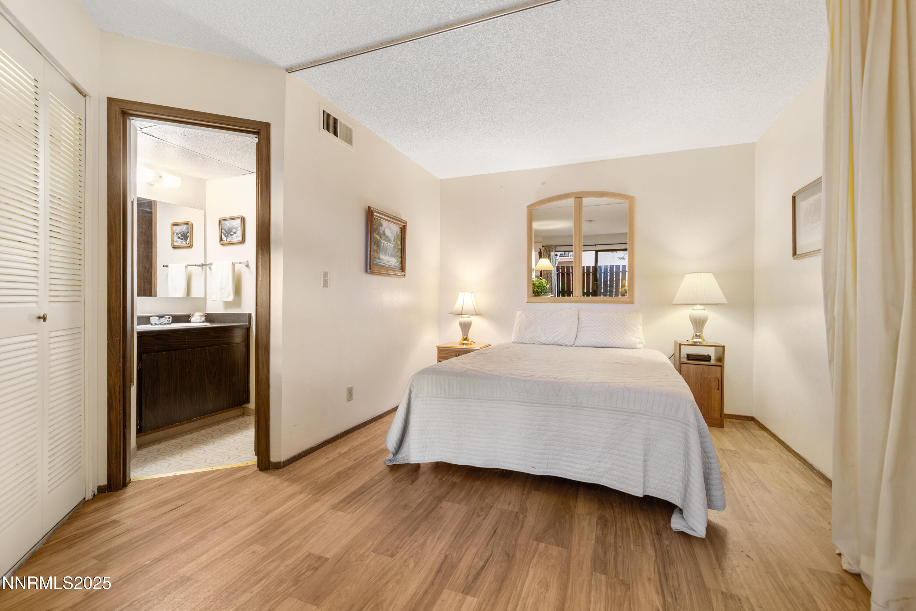 2750 Plumas Street, Unit 109 Reno, NV 89509 - Photo 4 of 19 a bedroom with a bed and wooden floor