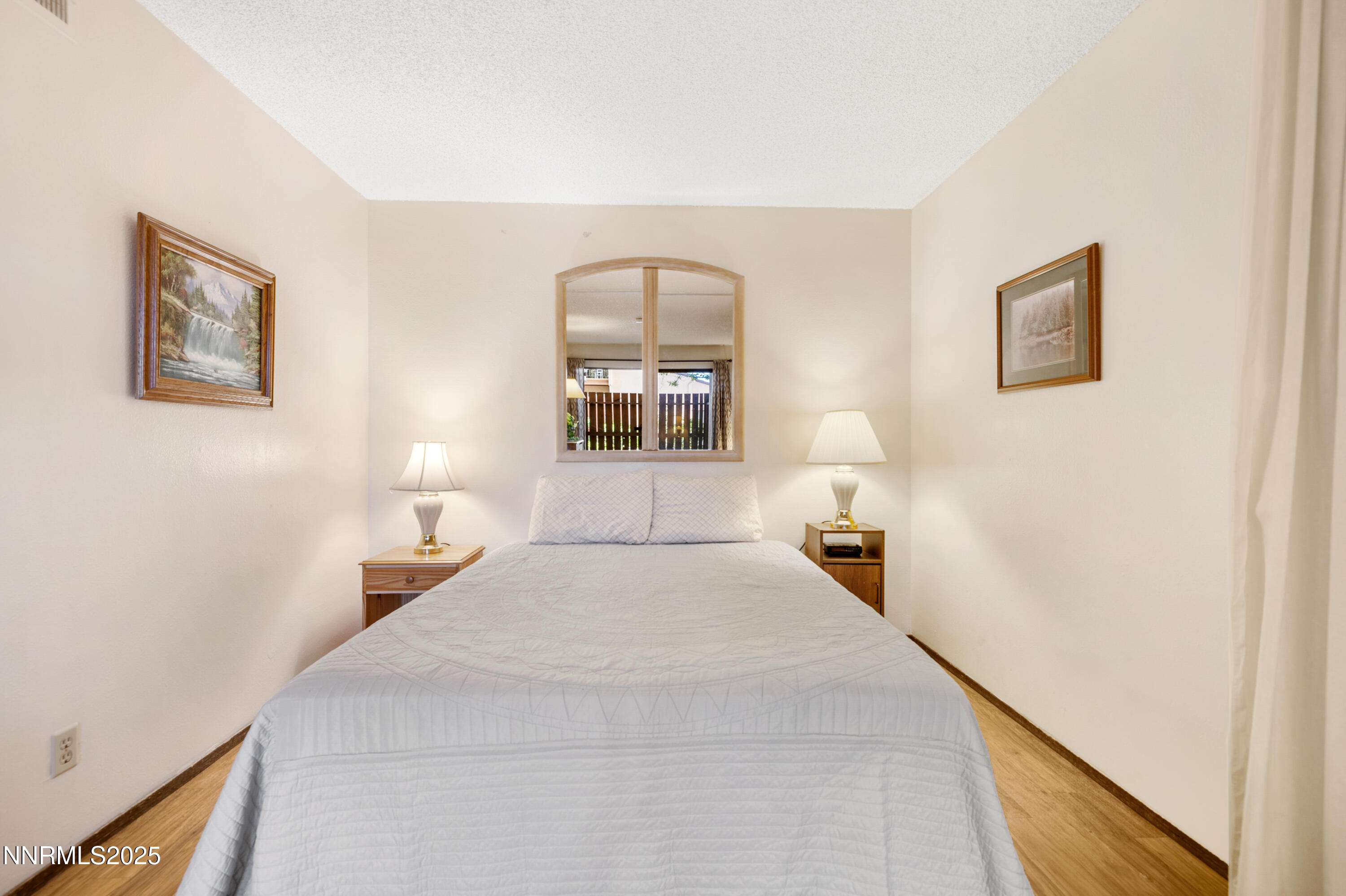 2750 Plumas Street, Unit 109 Reno, NV 89509 - Photo 5 of 19 a bedroom with a bed and a lamp