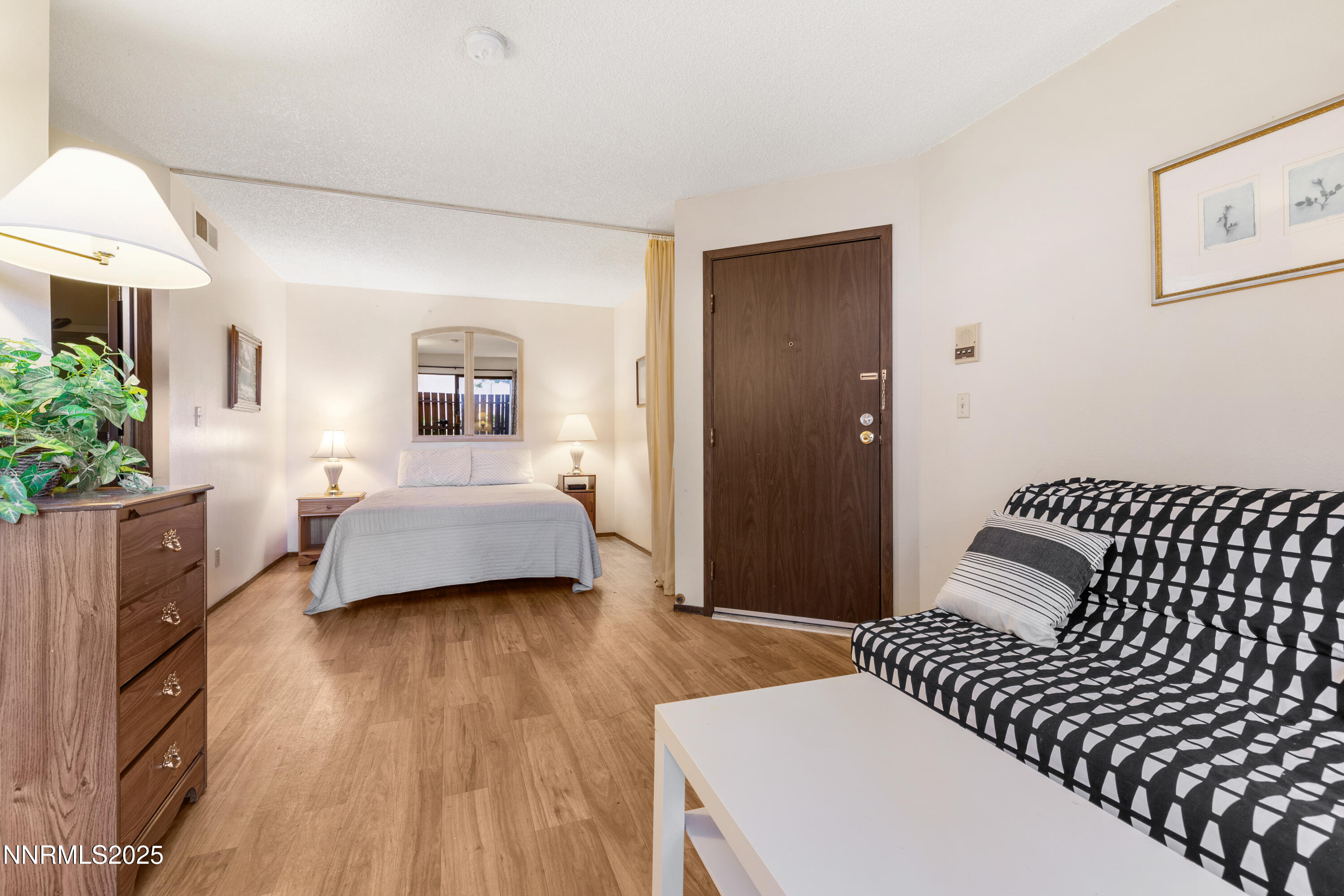 2750 Plumas Street, Unit 109 Reno, NV 89509 - Photo 6 of 19 a bedroom with a bed and a lamp