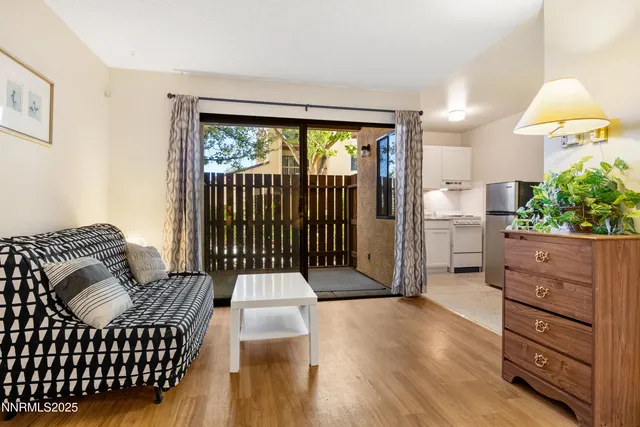 a living room with furniture and a lamp