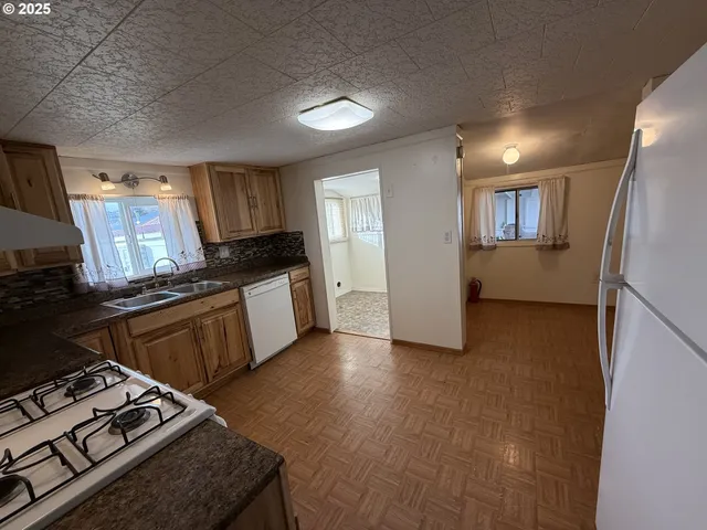 a kitchen with granite countertop a stove and a refrigerator