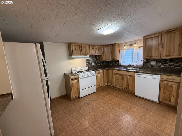 a kitchen with white cabinets sink and stainless steel appliances