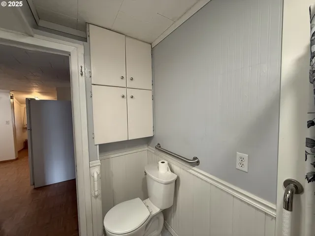 a white toilet sitting next to a bathroom sink