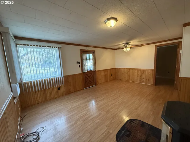 wooden floor in an empty room with a window