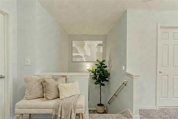 a living room with furniture and a potted plant