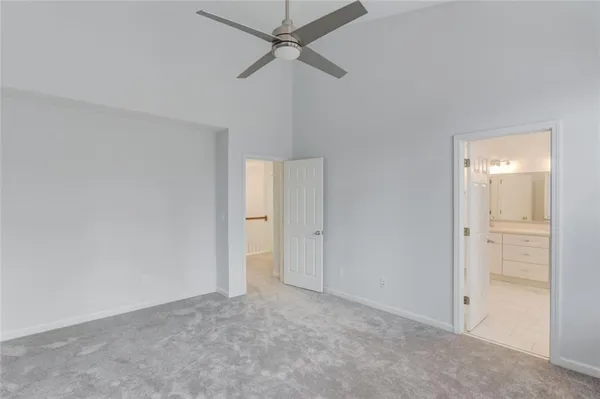 a spacious bathroom with a double vanity sink a mirror and a shower