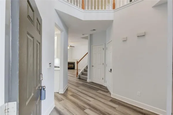 a view of a livingroom with stairs and an entryway