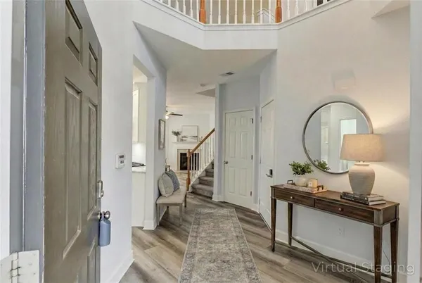 a living room with furniture a fireplace and a chandelier