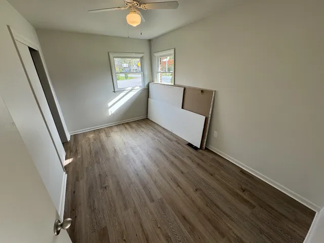 wooden floor in an empty room with a window