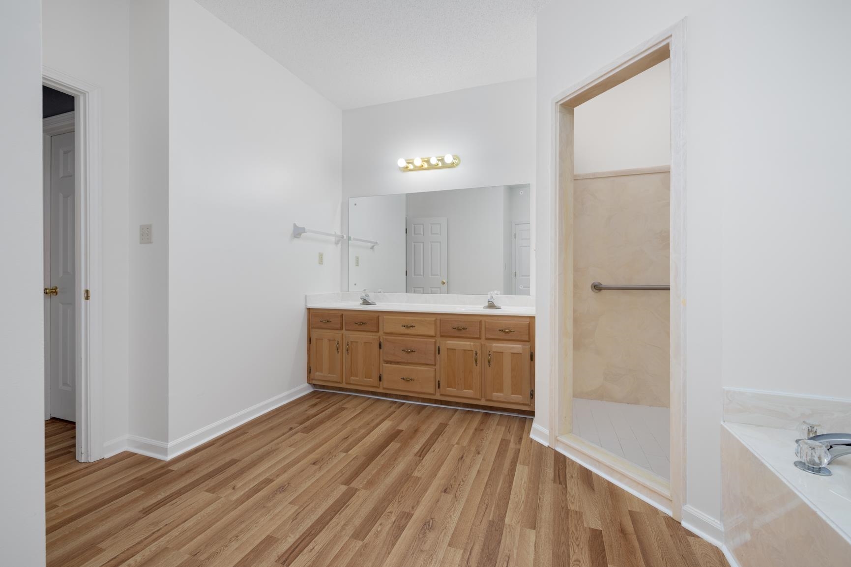 9015 Raspberry Lane Cordova, TN 38016 - Photo 26 of 40 Bathroom featuring hardwood / wood-style flooring, vanity, and separate shower and tub