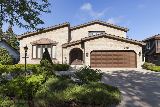 3915 Rugen Road Glenview, IL 60025 - Photo 1 of 11 a front view of a house with a yard and garage