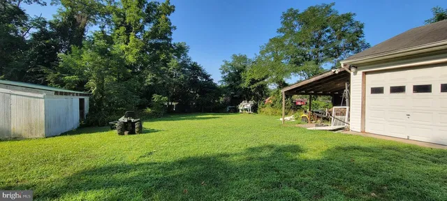 a view of a backyard with a sitting area and a garden