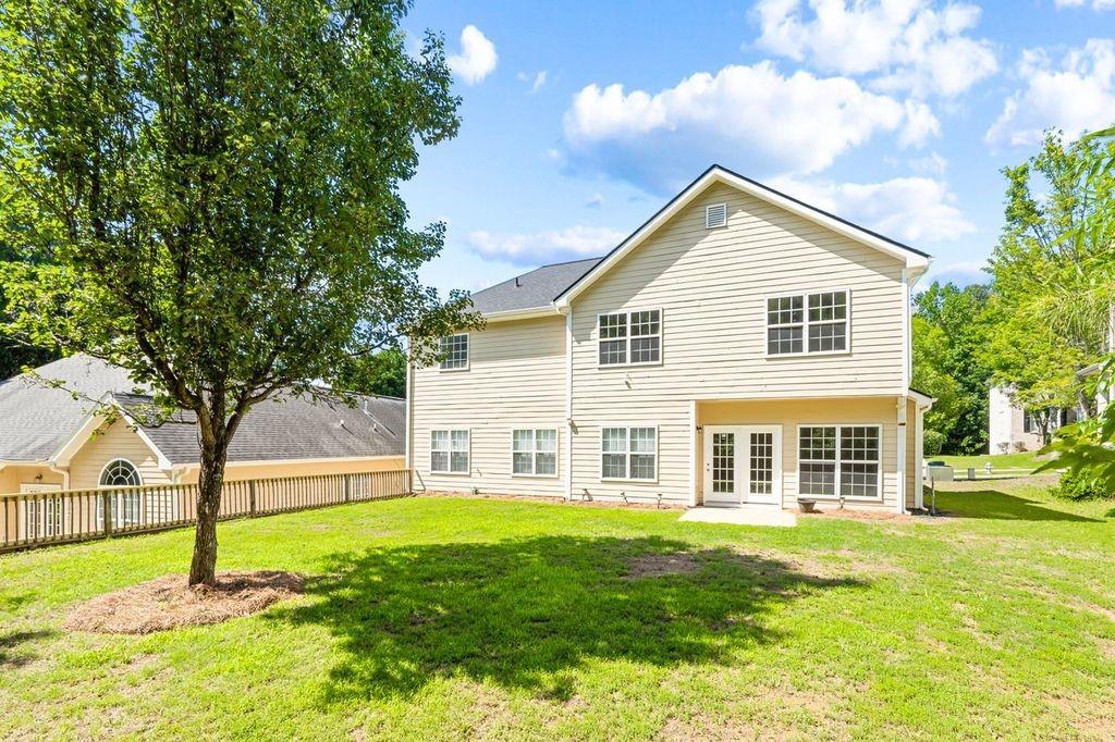 473 Greyhawk Way Fairburn, GA 30213 - Photo 31 of 34 a front view of house with yard and green space