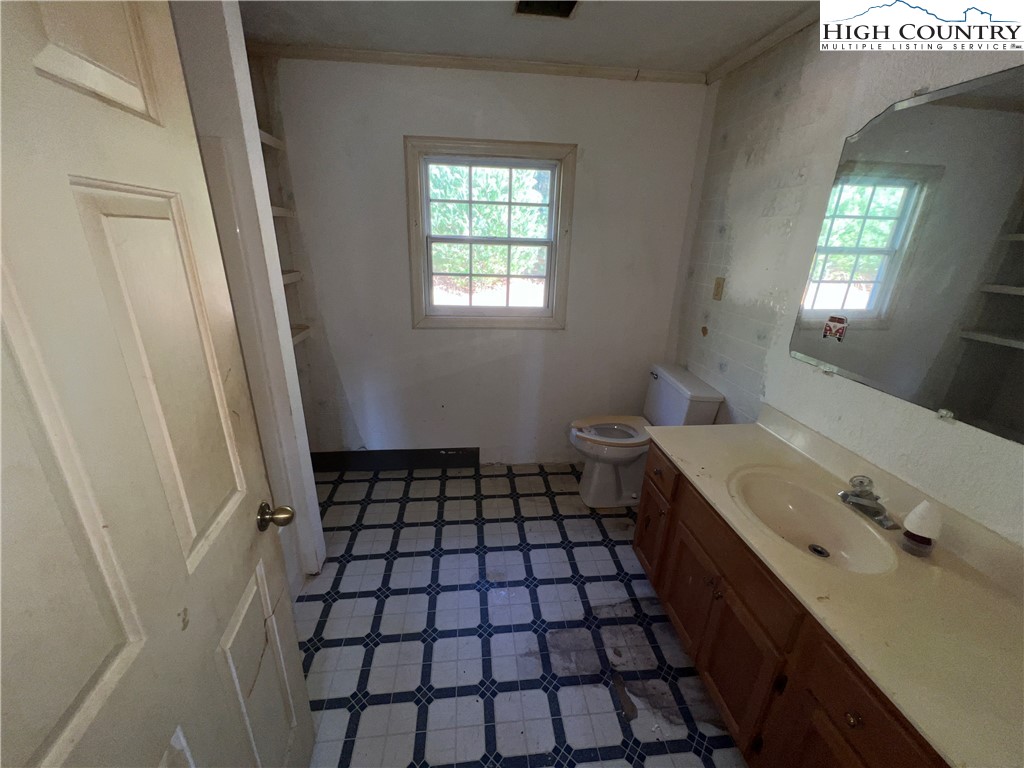 355 Round Knob Church Road West Jefferson, NC 28694 - Photo 13 of 23 a bathroom with a sink a toilet and a mirror
