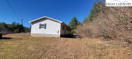 355 Round Knob Church Road West Jefferson, NC 28694 - Photo 20 of 23 a view of a house with a yard