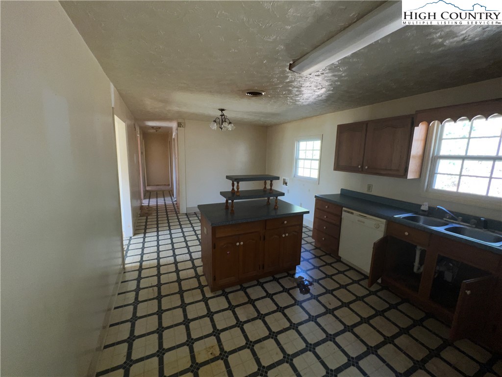 355 Round Knob Church Road West Jefferson, NC 28694 - Photo 2 of 23 a kitchen with a sink a counter top space and cabinets