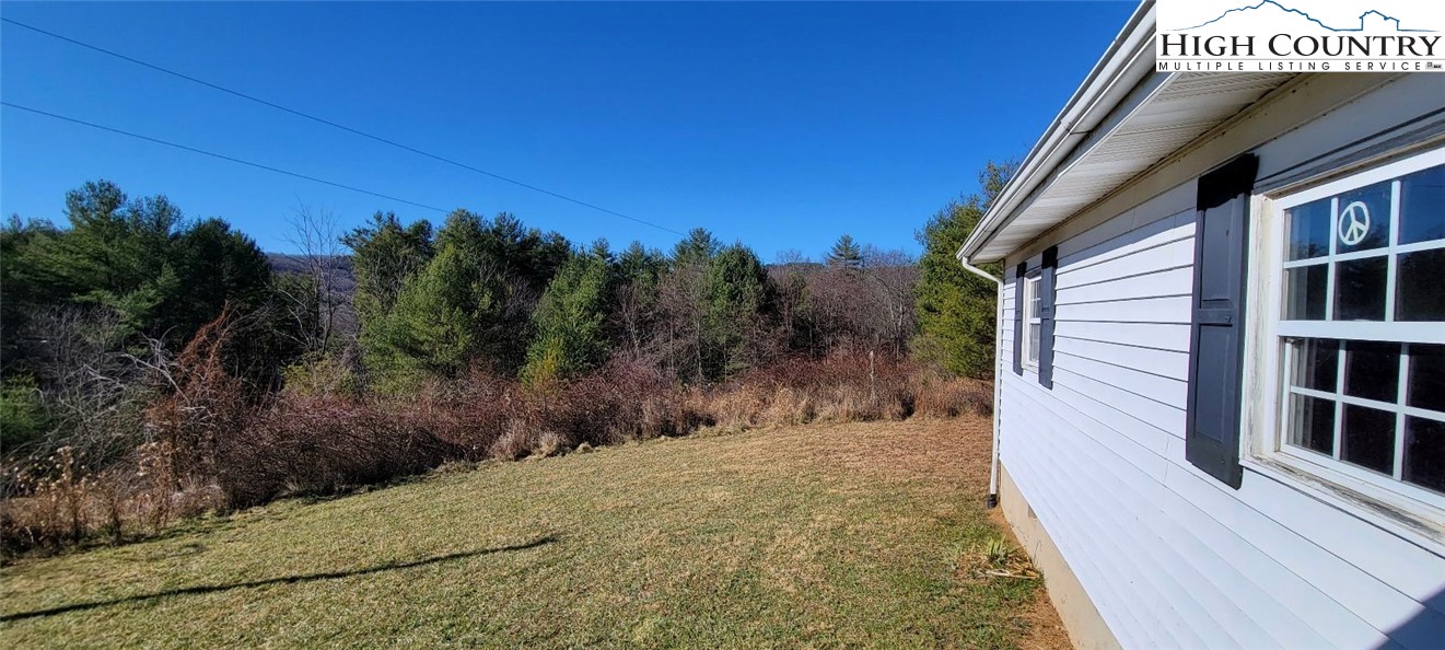 355 Round Knob Church Road West Jefferson, NC 28694 - Photo 21 of 23 a view of a house with a backyard