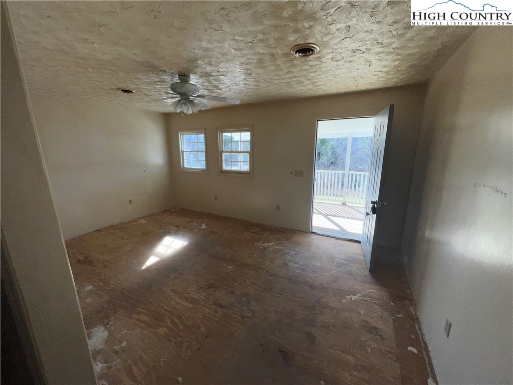 355 Round Knob Church Road West Jefferson, NC 28694 - Photo 3 of 23 an empty room with a empty space and windows