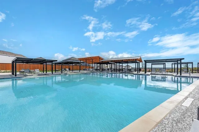 a view of swimming pool with seating space