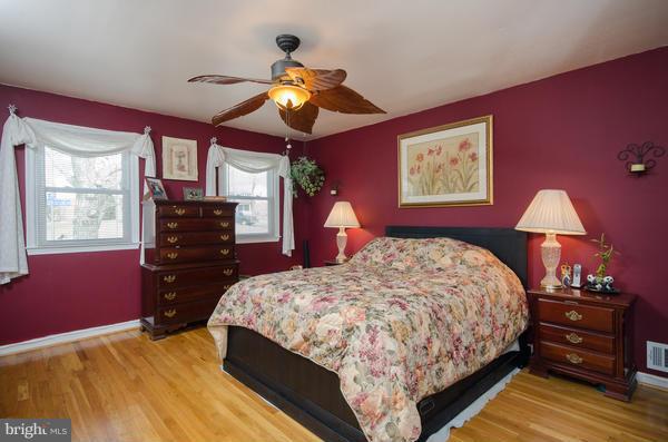 8011 Langbrook Road Springfield, VA 22152 - Photo 14 of 30 a bedroom with a bed and dresser with mirror