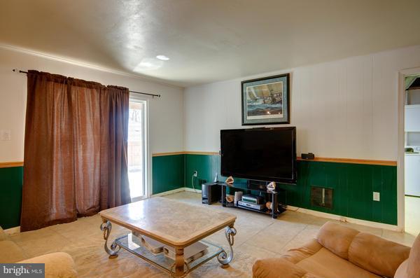 8011 Langbrook Road Springfield, VA 22152 - Photo 25 of 30 a living room with furniture and a flat screen tv