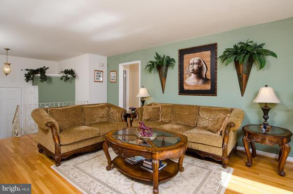 8011 Langbrook Road Springfield, VA 22152 - Photo 4 of 30 a living room with furniture and a potted plant