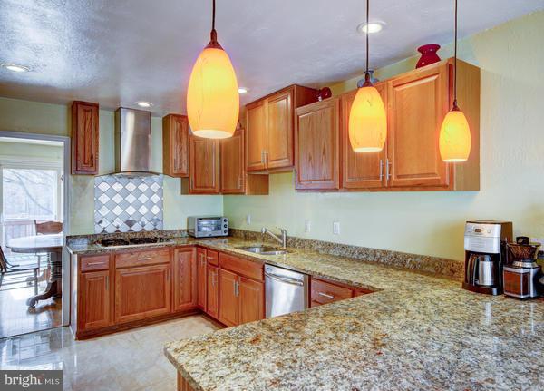 8011 Langbrook Road Springfield, VA 22152 - Photo 6 of 30 a kitchen with a sink a counter top space and stainless steel appliances