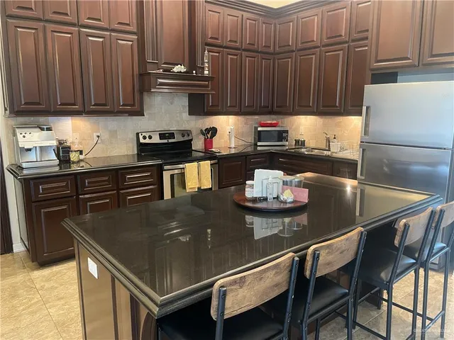 a kitchen with a dining table and chairs