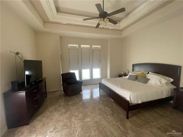 a bedroom with a bed and glass door