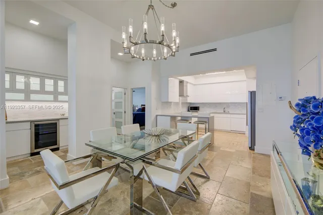 a view of a dining room with furniture and chandelier
